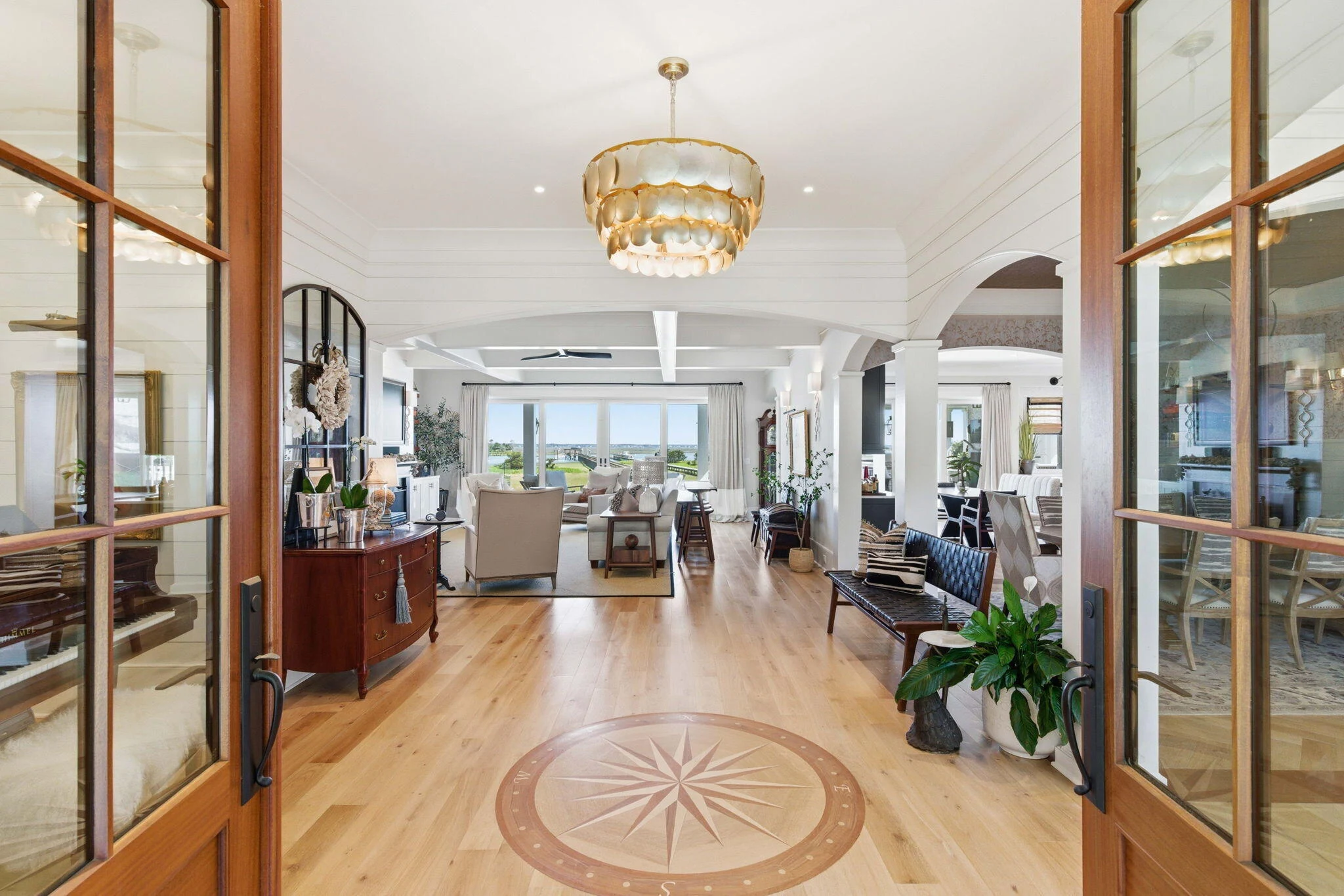 Mahogany doors opening onto the compass rose foyer