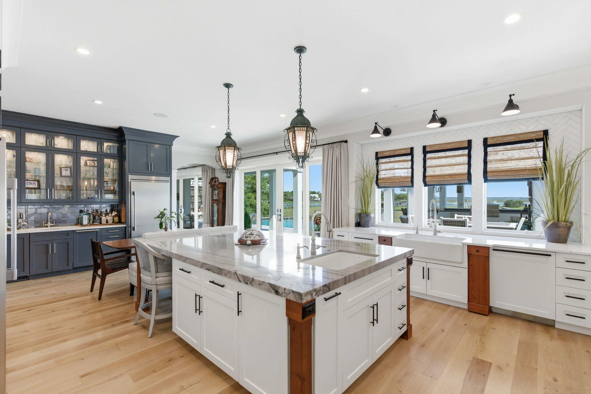 Custom kitchen with central island, statement lighting and dark cabinetry