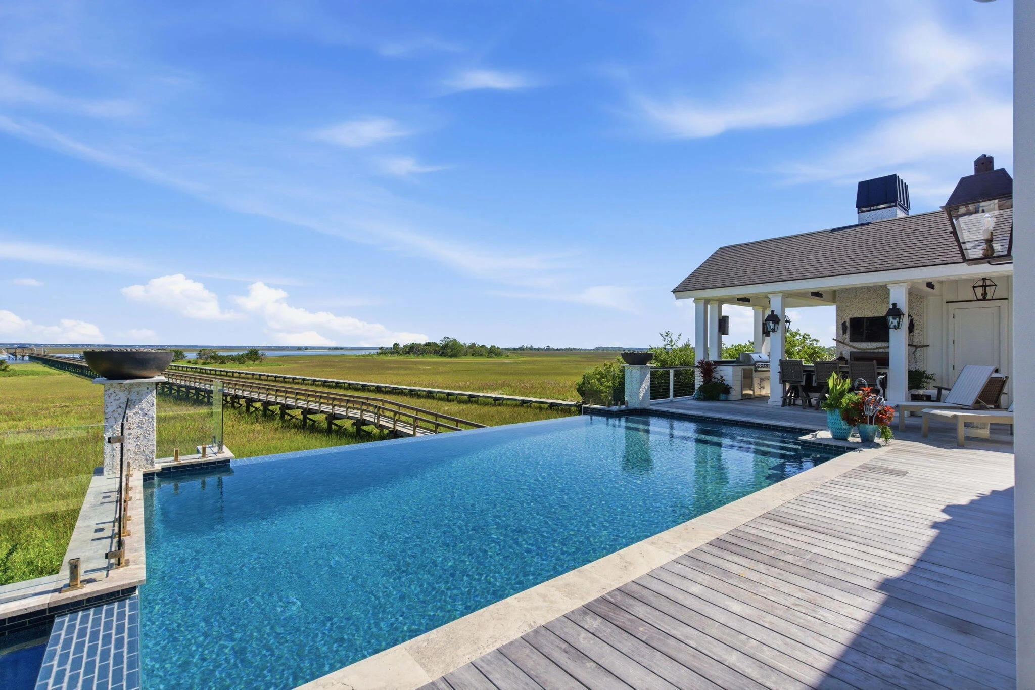 Heated saltwater pool and waterfront terrace overlooking the marsh and Intracoastal Waterway